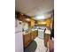 Compact kitchen featuring wooden cabinets, a white refrigerator, and tile flooring at 831 Sinyard Rd, Lithia Springs, GA 30122