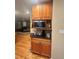 Kitchen cabinet with microwave, granite countertop, and wood floors leading to the living room at 831 Sinyard Rd, Lithia Springs, GA 30122