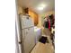 Functional laundry room featuring shelves, cabinets, fridge and laundry appliances at 831 Sinyard Rd, Lithia Springs, GA 30122