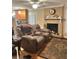 Comfortable living room featuring a cozy recliner sofa, brick fireplace, and view to the kitchen at 831 Sinyard Rd, Lithia Springs, GA 30122
