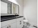 Modern bathroom with white cabinets, black hardware, granite countertop, and elegant marble flooring at 1045 Mcdaniel St, Atlanta, GA 30310