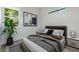 Serene bedroom showcasing a cozy bed, a modern art piece, and a window with a lush greenery view at 1045 Mcdaniel St, Atlanta, GA 30310