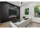 Stylish living room featuring a modern fireplace, dark accent wall, and a comfortable white sectional sofa at 1045 Mcdaniel St, Atlanta, GA 30310