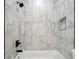 Bright shower showcasing marble tiles, black fixtures, and a built-in niche for storage at 1045 Mcdaniel St, Atlanta, GA 30310