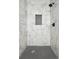 Stylish shower with marble tile walls, a black shower head, and a mosaic tile floor at 1045 Mcdaniel St, Atlanta, GA 30310