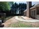 Spacious backyard with a brick wall, walkway, and lush greenery at 84 Nw Gloster Nw Rd, Lawrenceville, GA 30044