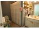 Bathroom featuring a neutral wall color, toilet, shower and decorative, rounded wall shelving at 84 Nw Gloster Nw Rd, Lawrenceville, GA 30044