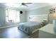 Bedroom boasting a ceiling fan, natural light, wood floors, a built-in headboard and neutral colors at 84 Nw Gloster Nw Rd, Lawrenceville, GA 30044