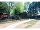 A metal fence encloses the backyard with a brown building and mature trees at 84 Nw Gloster Nw Rd, Lawrenceville, GA 30044