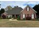 Charming single-story brick home with manicured lawn and mature landscaping offering classic curb appeal at 84 Nw Gloster Nw Rd, Lawrenceville, GA 30044