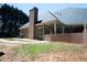 Brick home exterior with a covered patio, white columns, and a landscaped yard at 84 Nw Gloster Nw Rd, Lawrenceville, GA 30044