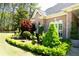 Brick home exterior with manicured landscaping, arched windows, and mature trees at 84 Nw Gloster Nw Rd, Lawrenceville, GA 30044