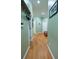Hallway featuring wood floors, light green walls, and various doors, with art pieces on the walls at 84 Nw Gloster Nw Rd, Lawrenceville, GA 30044
