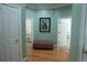 Hallway with hardwood floors, light green walls, white doors, and a decorative ottoman at 84 Nw Gloster Nw Rd, Lawrenceville, GA 30044