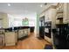 Kitchen featuring wooden cabinets, stainless appliances, hardwood floors, and open layout at 84 Nw Gloster Nw Rd, Lawrenceville, GA 30044