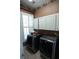 Convenient laundry room with front loading washer and dryer, and updated cabinets at 84 Nw Gloster Nw Rd, Lawrenceville, GA 30044