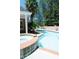 Beautiful in-ground pool with attached spa, surrounded by brick and lush landscaping at 84 Nw Gloster Nw Rd, Lawrenceville, GA 30044
