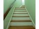 Clean stairway with wooden steps and green walls at 84 Nw Gloster Nw Rd, Lawrenceville, GA 30044