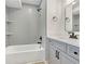 Beautiful bathroom featuring modern gray subway tile, a tub, and brushed bronze fixtures at 193 High Creek Dr, Roswell, GA 30076