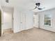 This bedroom features a ceiling fan, large windows, and neutral carpeting at 193 High Creek Dr, Roswell, GA 30076