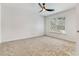 Bright carpeted bedroom with ceiling fan and natural light at 193 High Creek Dr, Roswell, GA 30076