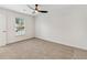 A light-filled bedroom with neutral carpeting and a ceiling fan at 193 High Creek Dr, Roswell, GA 30076