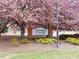 Holcomb's Crossing community sign surrounded by beautiful trees and landscaping at 193 High Creek Dr, Roswell, GA 30076