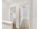 Upstairs hallway between carpeted bedrooms at 193 High Creek Dr, Roswell, GA 30076