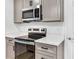 Modern kitchen features stainless steel appliances, quartz countertops, and shaker cabinets at 193 High Creek Dr, Roswell, GA 30076