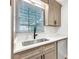 Kitchenette sink features stone countertops, modern cabinets and fixtures plus natural lighting at 193 High Creek Dr, Roswell, GA 30076