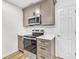 Kitchenette area with modern stainless steel appliances, stone countertops, and stylish cabinets at 193 High Creek Dr, Roswell, GA 30076
