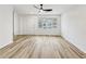 Spacious living room featuring modern wood floors and a large window for ample lighting at 193 High Creek Dr, Roswell, GA 30076
