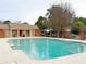 A community swimming pool featuring clear blue water and a bath house in the background at 193 High Creek Dr, Roswell, GA 30076