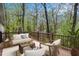 Relaxing back deck showcasing outdoor seating with views of a lush, wooded backyard at 2183 Seaman Cir, Atlanta, GA 30341