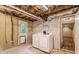 Unfinished basement with laundry area and exterior door at 2183 Seaman Cir, Atlanta, GA 30341