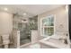 Bathroom featuring a glass-enclosed shower, double sinks, and a window at 2183 Seaman Cir, Atlanta, GA 30341