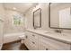 Bathroom featuring double sinks, marble countertops, and a shower-tub combination with marble tiling at 2183 Seaman Cir, Atlanta, GA 30341