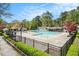 Large community pool with a fence, beautiful trees, and a blue sky at 2183 Seaman Cir, Atlanta, GA 30341