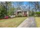 Well-maintained home with a brick facade, manicured lawn, mature trees, and a long driveway at 2183 Seaman Cir, Atlanta, GA 30341