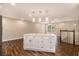 Spacious kitchen featuring a center island with pendant lighting, wood floors and access to stairs at 2183 Seaman Cir, Atlanta, GA 30341