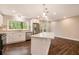 A modern kitchen featuring white cabinets, stainless steel appliances, hardwood floors, and a center island at 2183 Seaman Cir, Atlanta, GA 30341