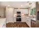 Modern kitchen features white cabinets, stainless steel appliances, and countertops with stainless steel sink at 2183 Seaman Cir, Atlanta, GA 30341