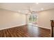 A bright room with hardwood floors, a ceiling fan, and a large window with a view of trees at 2183 Seaman Cir, Atlanta, GA 30341