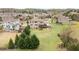 Aerial view showcases a community with well-maintained homes, lush landscaping, and a picturesque pond at 260 Millstone Pkwy, Woodstock, GA 30188