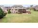 Vast backyard featuring a deck, covered patio, firepit area, and lush lawn perfect for outdoor activities at 260 Millstone Pkwy, Woodstock, GA 30188