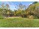Lush backyard extending to a peaceful pond, offering a serene natural setting at 260 Millstone Pkwy, Woodstock, GA 30188