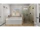 This bathroom features a soaking tub, a tiled shower, and granite countertops at 260 Millstone Pkwy, Woodstock, GA 30188