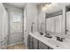 Bright bathroom with double sink vanity, modern fixtures, and natural light from the window at 260 Millstone Pkwy, Woodstock, GA 30188