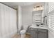 Bathroom featuring a shower with curtain, a toilet, vanity, and window with blinds at 260 Millstone Pkwy, Woodstock, GA 30188
