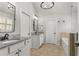 This full bathroom features double sinks, granite countertops, tiled floors, and ample lighting at 260 Millstone Pkwy, Woodstock, GA 30188